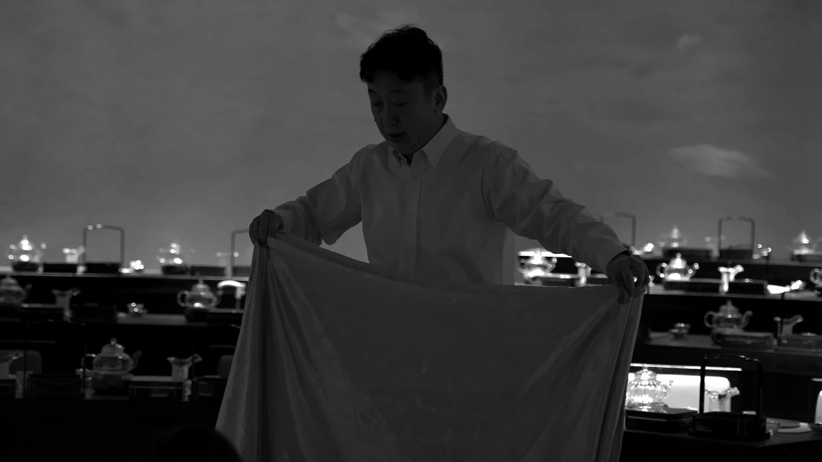 Weiping Ji demonstrates a movement with a length of cloth