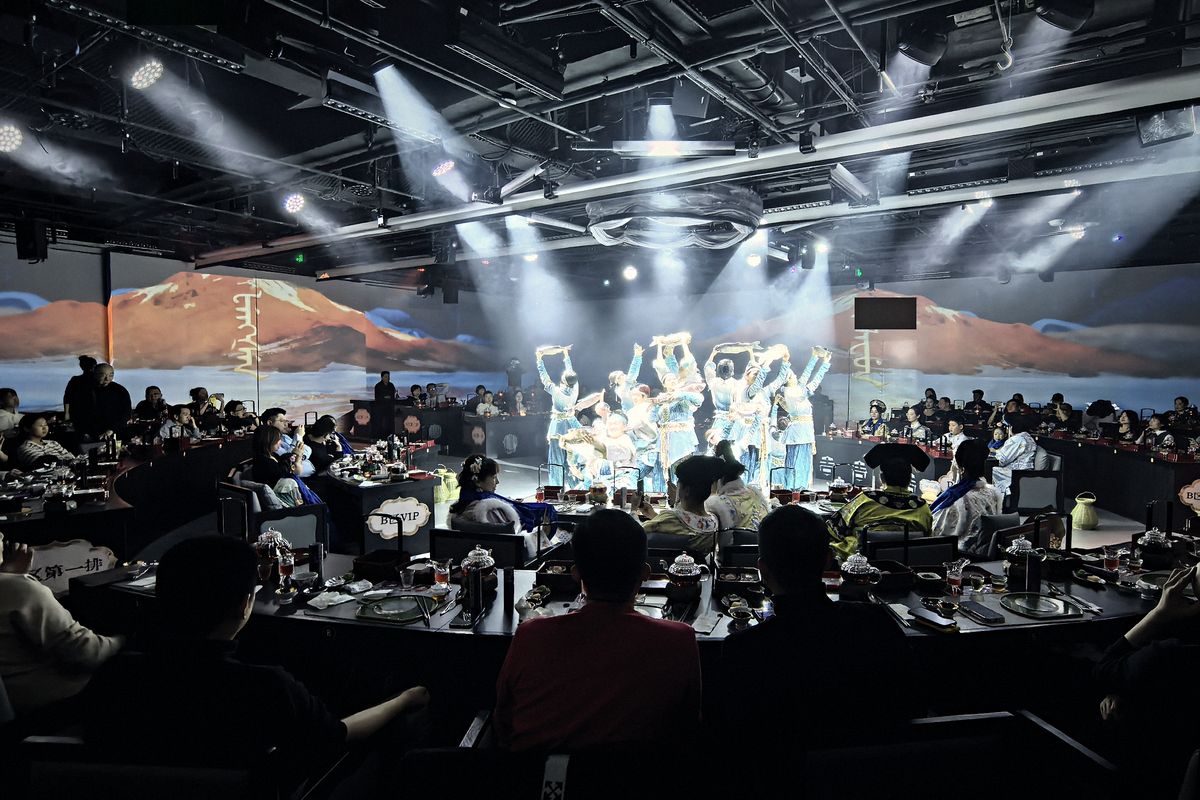 Act III, Winter Fishing: dancers in white under the stage lights, the full banquet hall around them