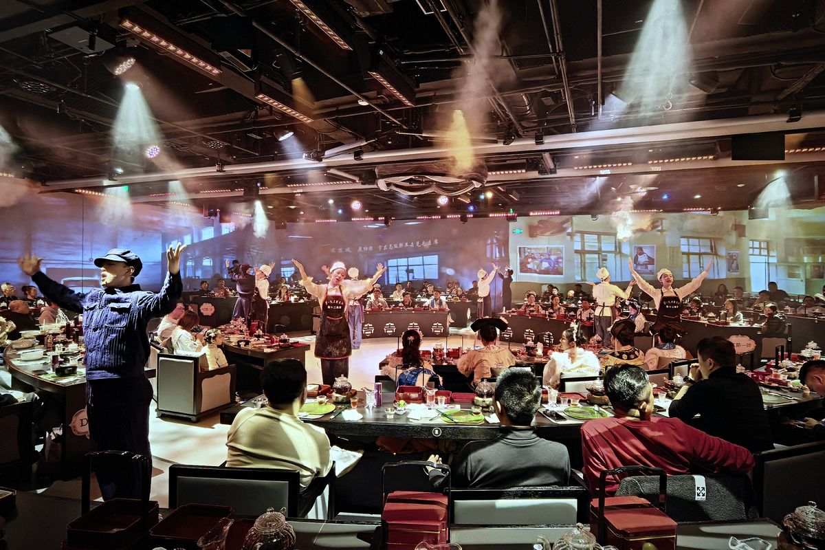 Act V, Setting Sail: performers among the banquet tables in the full hall